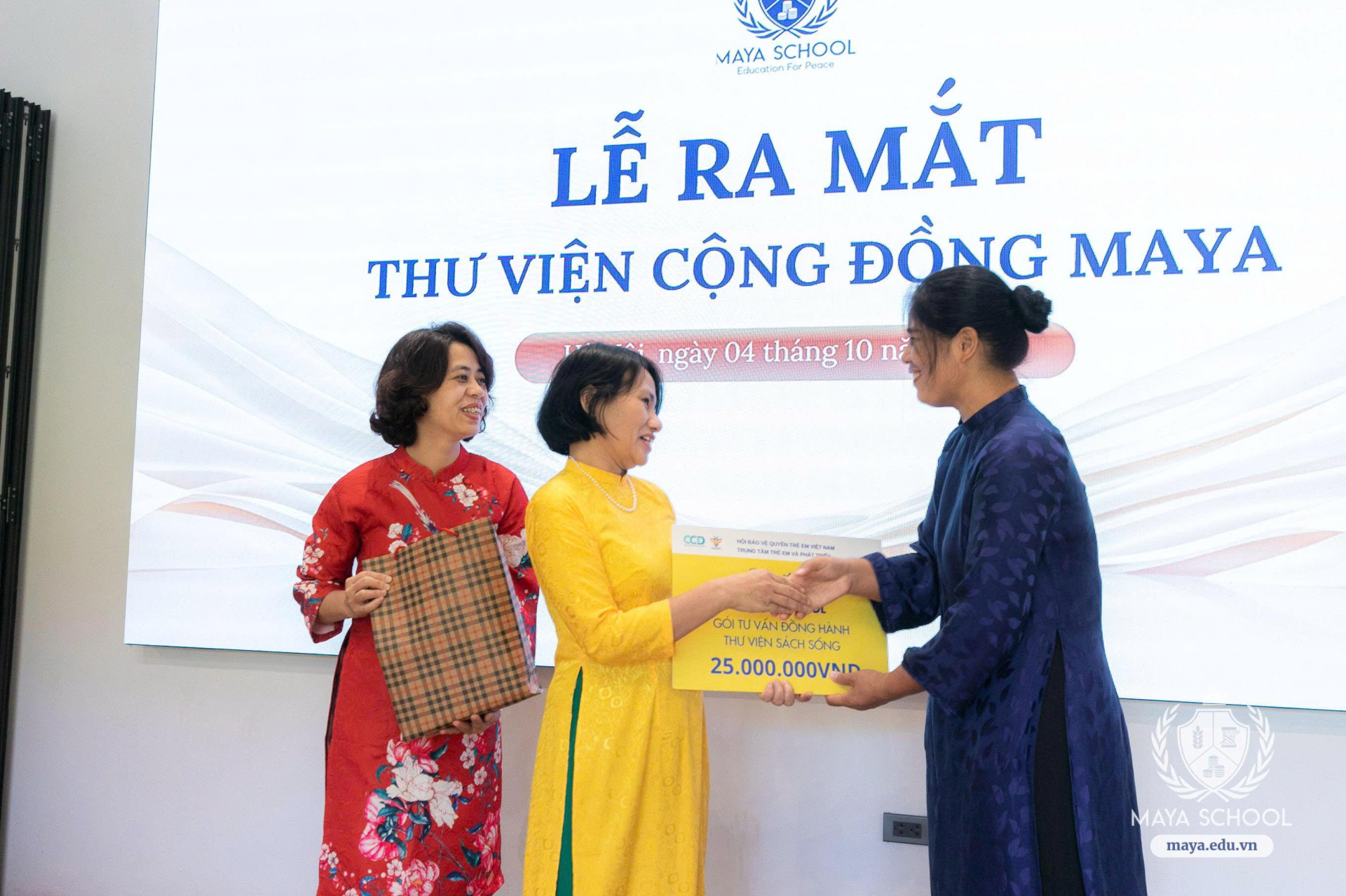 Bà Phí Thị Mai Chi (áo dài vàng) – Sáng lập Trung tâm Trẻ em và Phát triển (CCD), sáng lập dự án Happy Reading trao tặng Trường Phổ thông liên cấp song ngữ Maya gói tư vấn đồng hành Thư viện sách sống maya