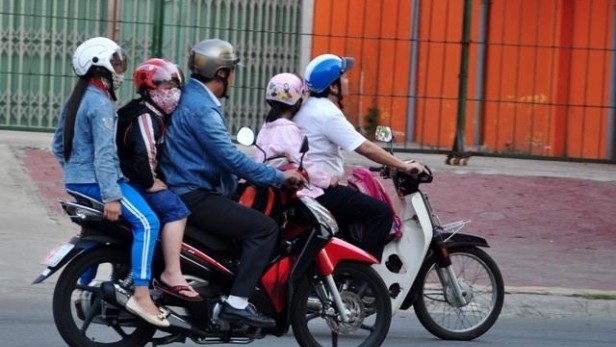 Đội mũ bảo hiểm đúng cách cho trẻ khi ngồi xe máy